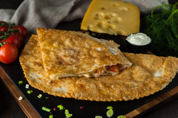 Cheburek with three cheeses and tomatoes